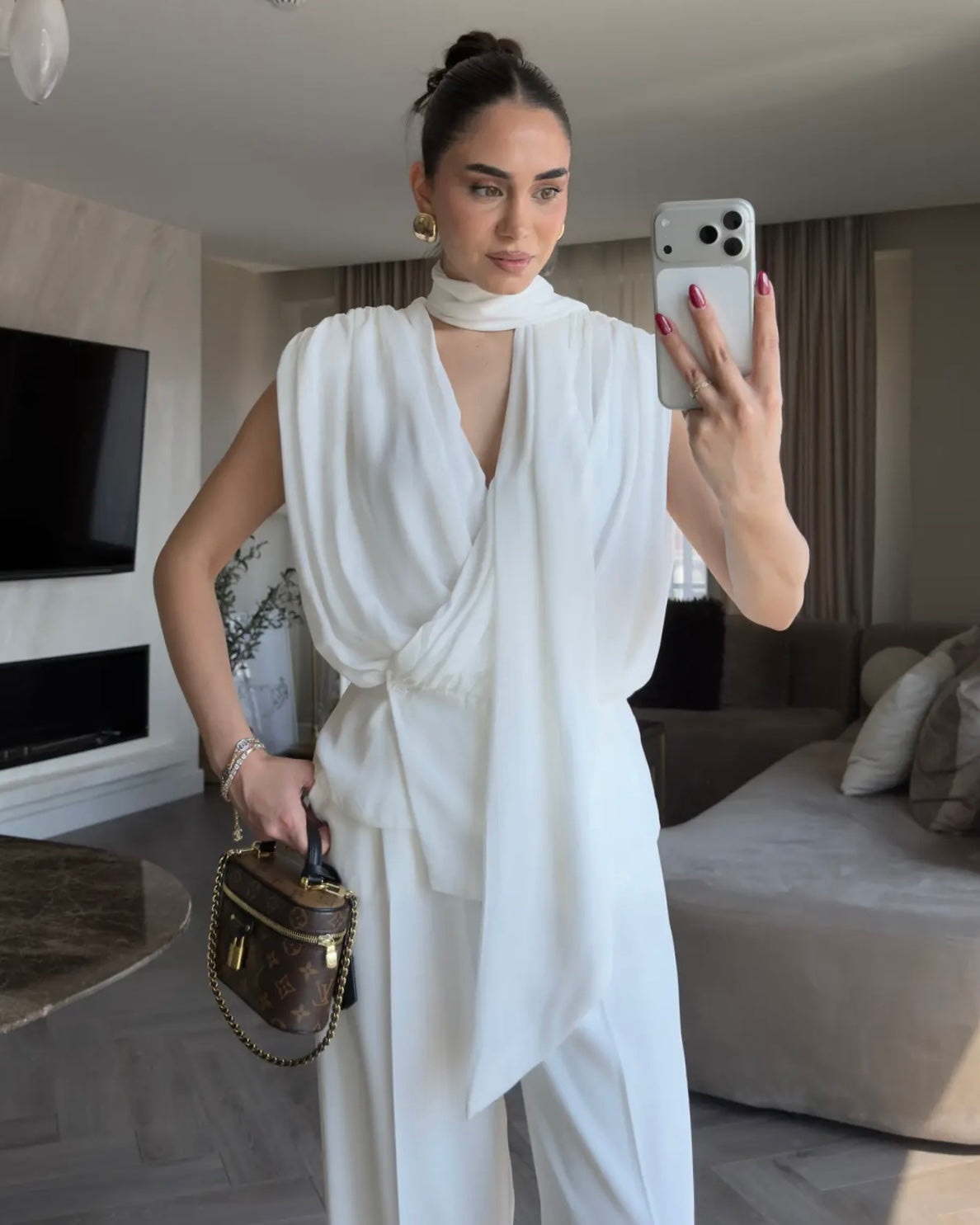 Elegant Black Draped Sleeveless Blouse with Scarf Detail | بلوزة سودة أنيقة بقصة درابيه وياقة شال