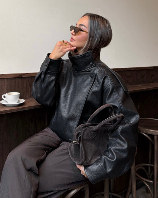 Black Oversized Leather Biker Jacket with High Stand Collar & Snap Buttons | جاكيت جلد أسود أوفر سايز بقصة بايكر وياقة عالية وأزرار كبس