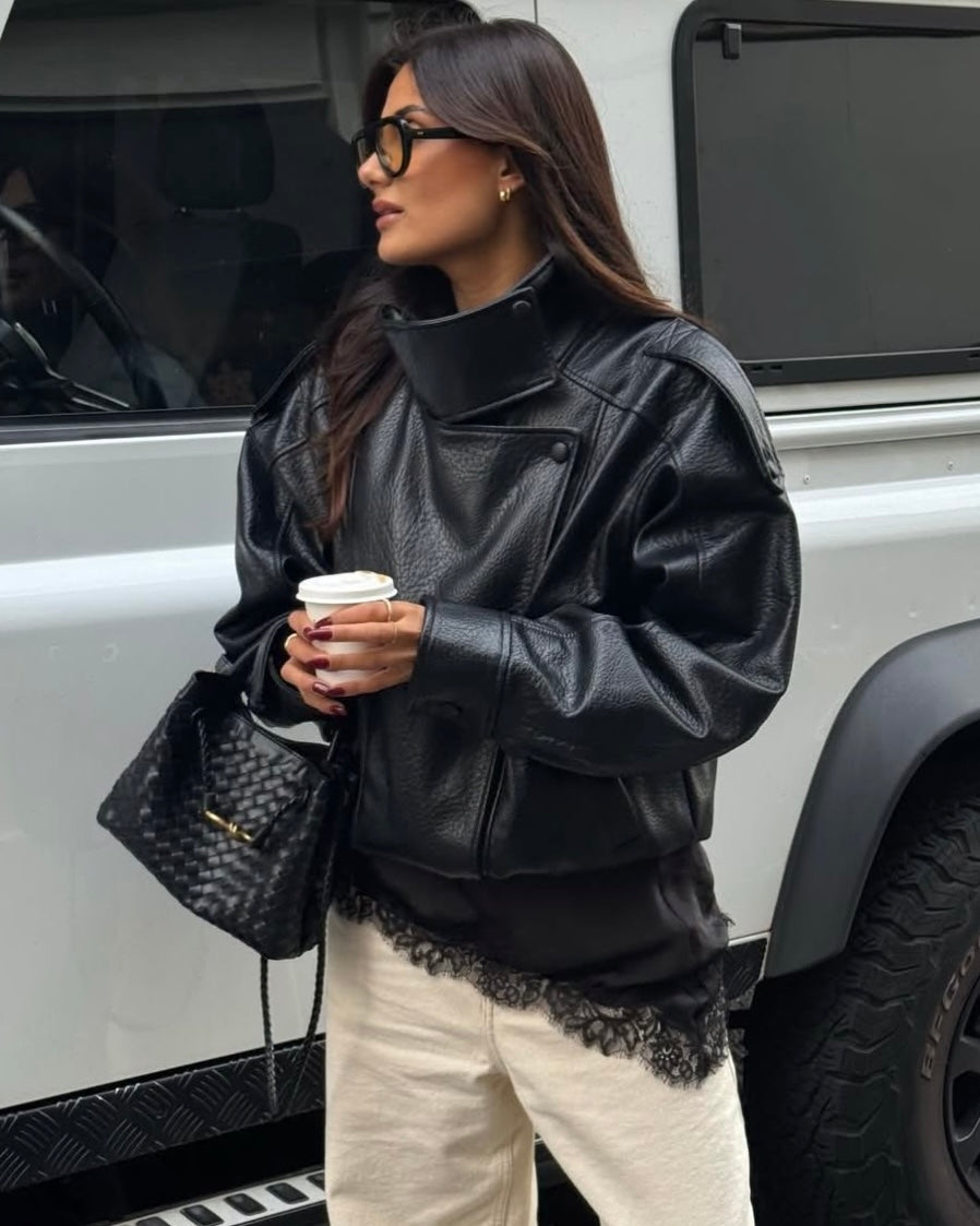 Black Oversized Leather Biker Jacket with High Stand Collar & Snap Buttons | جاكيت جلد أسود أوفر سايز بقصة بايكر وياقة عالية وأزرار كبس