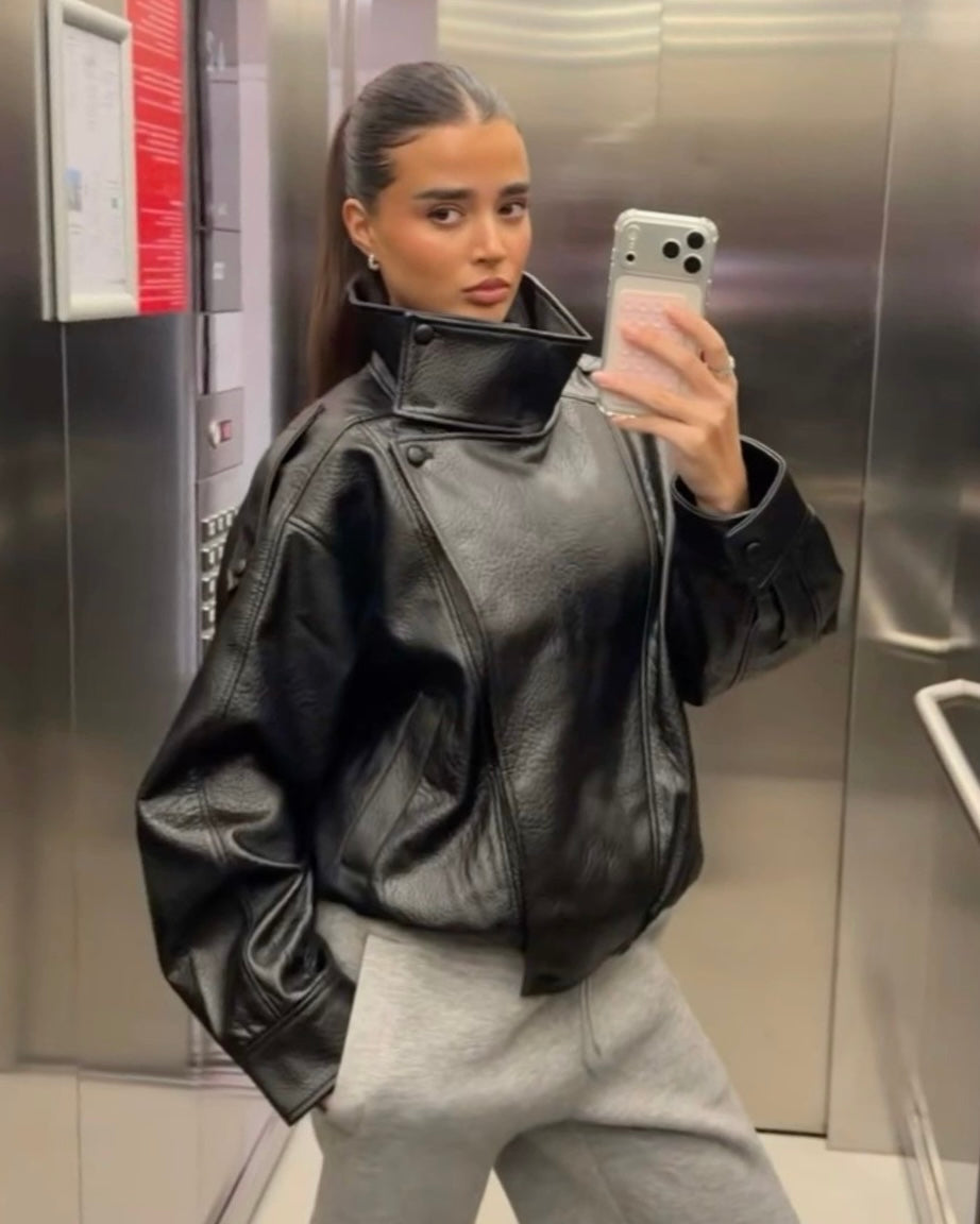 Black Oversized Leather Biker Jacket with High Stand Collar & Snap Buttons | جاكيت جلد أسود أوفر سايز بقصة بايكر وياقة عالية وأزرار كبس